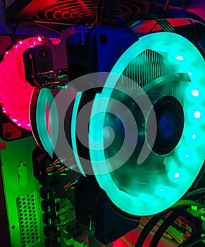 Modern computer air cooling with multi-colored led backlight-fans, cooling radiators, cables, boards, close-up, macro.