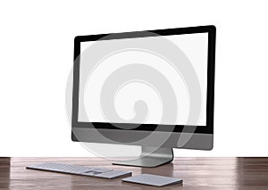 Modern computer with blank monitor screen and peripherals on wooden table against white background