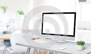 Modern computer display mockup on office desk. Modern studio with clean work desk