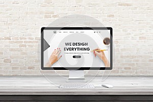 Modern computer display with web design agency page on office, studio desk. Flat design concept