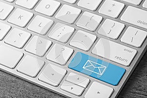 Modern computer keyboard with envelope sign on button, closeup view. Sending email letters