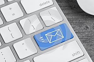 Modern keyboard with envelope sign on button, closeup view. Sending email letters