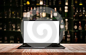 Modern computer,laptop on counter bar with blur wine bottle photo