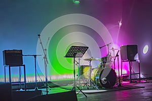 modern concert stage with musical instruments  bright neon lights