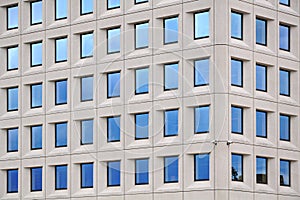 Modern concrete building with blue sky windows