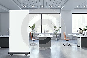 Modern concrete coworking office interior with empty white roll-up banner, panoramic windows and city view. 3D Rendering