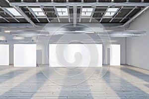 Modern concrete and wooden exhibition hall interior with empty white mock up banners and sunlight.