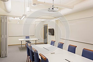 Modern conference / meeting room isolated. White office table and blue chairs. Business concept. Modern office style.