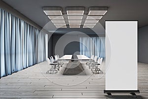 Modern conference room interior with blank white mock up roll up banner, furniture, wooden flooring and blue curtains. Boardroom