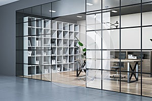 Modern conference room interior with glass partition, wooden flooring and bookcase.