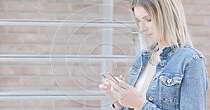 Modern Connectivity: Young Woman Using Smartphone in Urban Setting