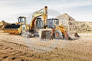 Modern construction machinery at a construction site in a quarry. Powerful modern equipment for earthworks. Rental of construction