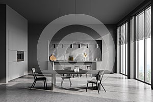 Modern contemporary design kitchen room interior. Dining table with chairs. Panoramic windows. Dark grey and concrete material