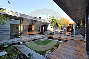 Modern contemporary illuminated house design exterior. Luxurious new construction home with panoramic windows, pool