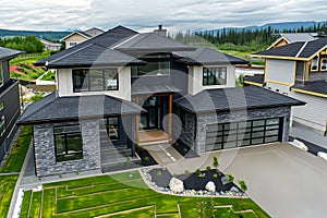 Modern contemporary illuminated house design exterior. Luxurious new construction home with panoramic windows, pool