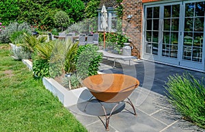 Modern contemporary patio in an English country garden