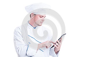Modern cook or chef using a wireless tablet pc