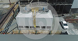 Modern cooling tower close-up. An engineer at a modern cooling tower. Modern industrial water cooling system. Industrial