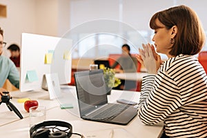 Modern corporate office open space with busy male and female staff employees using laptop computers sitting at work in