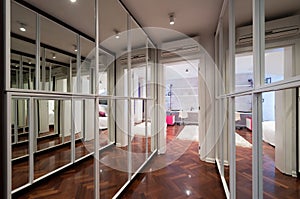 Modern corridor interior with mirror wardrobe doors