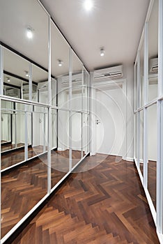 Modern corridor interior with mirror wardrobe doors