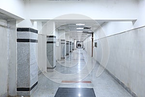 Modern corridor of a newly constructed hospital building with grey tiles and marbles.