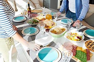 Modern Couple Setting Dinner Table