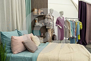 Modern cozy bedroom with a double bed, pillows and a blanket. A store selling beds and sleeping accessories. Mannequin in modern