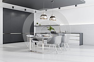 Modern cozy bright furnished kitchen with chairs, table and lamps, white concrete floor and a black empty wall. Interior design