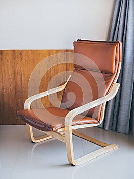 Modern cozy brown leather and wooden armchair