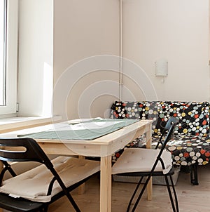 Modern cozy home interior dining white room with wooden table, chairs and sofa