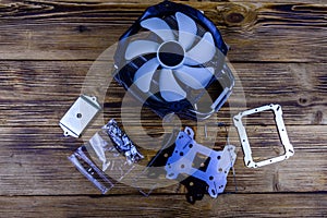 Modern cpu cooler with heat pipes and installation kit on a wooden background