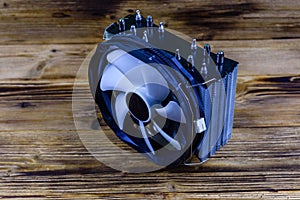 Modern cpu cooler with heat pipes on a wooden background