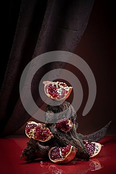 Modern creative food photography - pieces of ripe pomegranate.