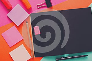 Modern creative work space with stylish black notepad