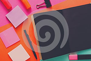 Modern creative work space with stylish black notepad