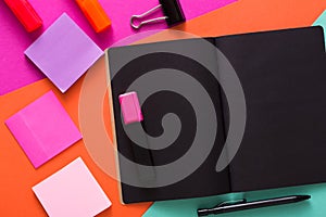 Modern creative work space with stylish black notepad