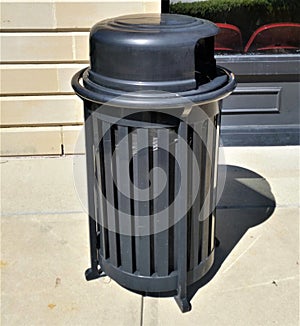 Modern cylindrical black trash receptacle