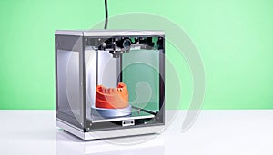 Modern 3D Printer Creating an Orange Prototype