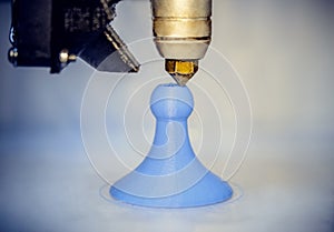 Modern 3D printer printing figure close-up