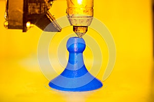 Modern 3D printer printing figure close-up