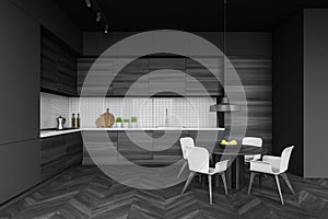 Modern dark kitchen interior with round table