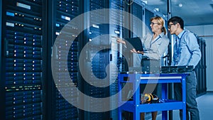 In the Modern Data Center: Engineer and IT Specialist Work with Server Racks, on a Pushcart Equipm