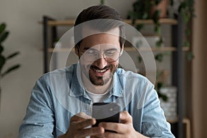 Modern day young man addicted to gadget using smartphone