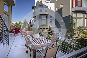 Modern deck in townhouse with chairs and table