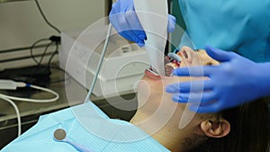 Modern dental clinic concept. Orthodontist using 3D intraoral scanner for scanning patient teeth. Manual teeth scanner