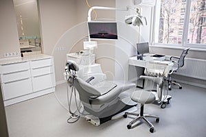 Modern Dental Clinic, Dentist chair and other accessories used by dentists in medical light. Dental surgeon, is a
