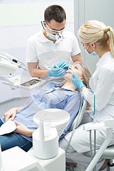 Modern dental clinic, young dentist working