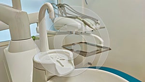 Modern dental office. Dental chair and other accessories used by dentists in blue, medical light