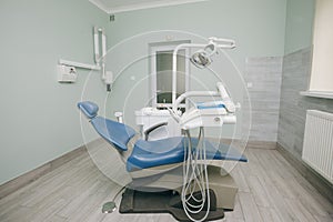 Modern dental practice. Dental chair and other accessories used by dentists in blue, medic light. Dentist Office, Dental